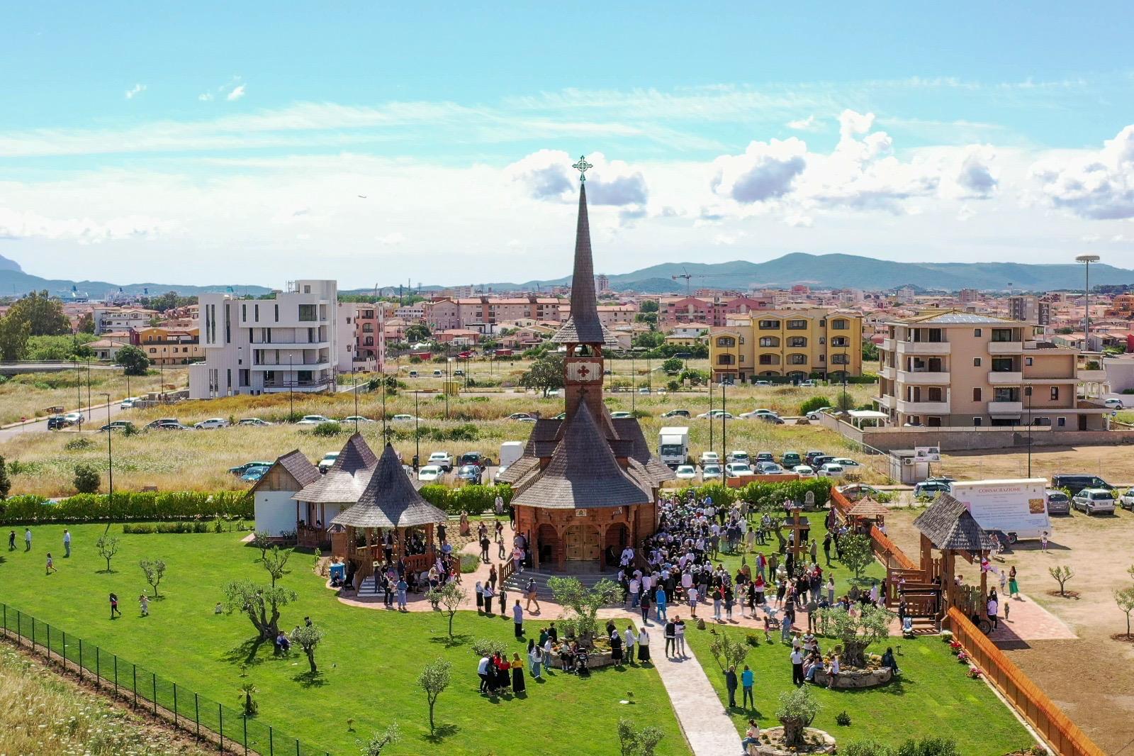 A community gathered around a wooden church