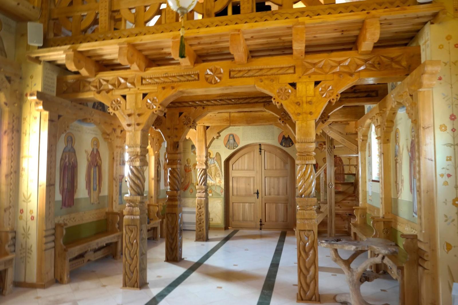 Carved wooden columns and painted walls inside a church