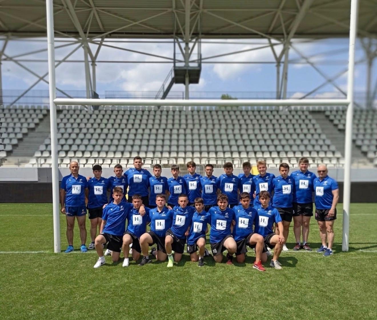 A rugby team in blue shirts photographed at a stadium