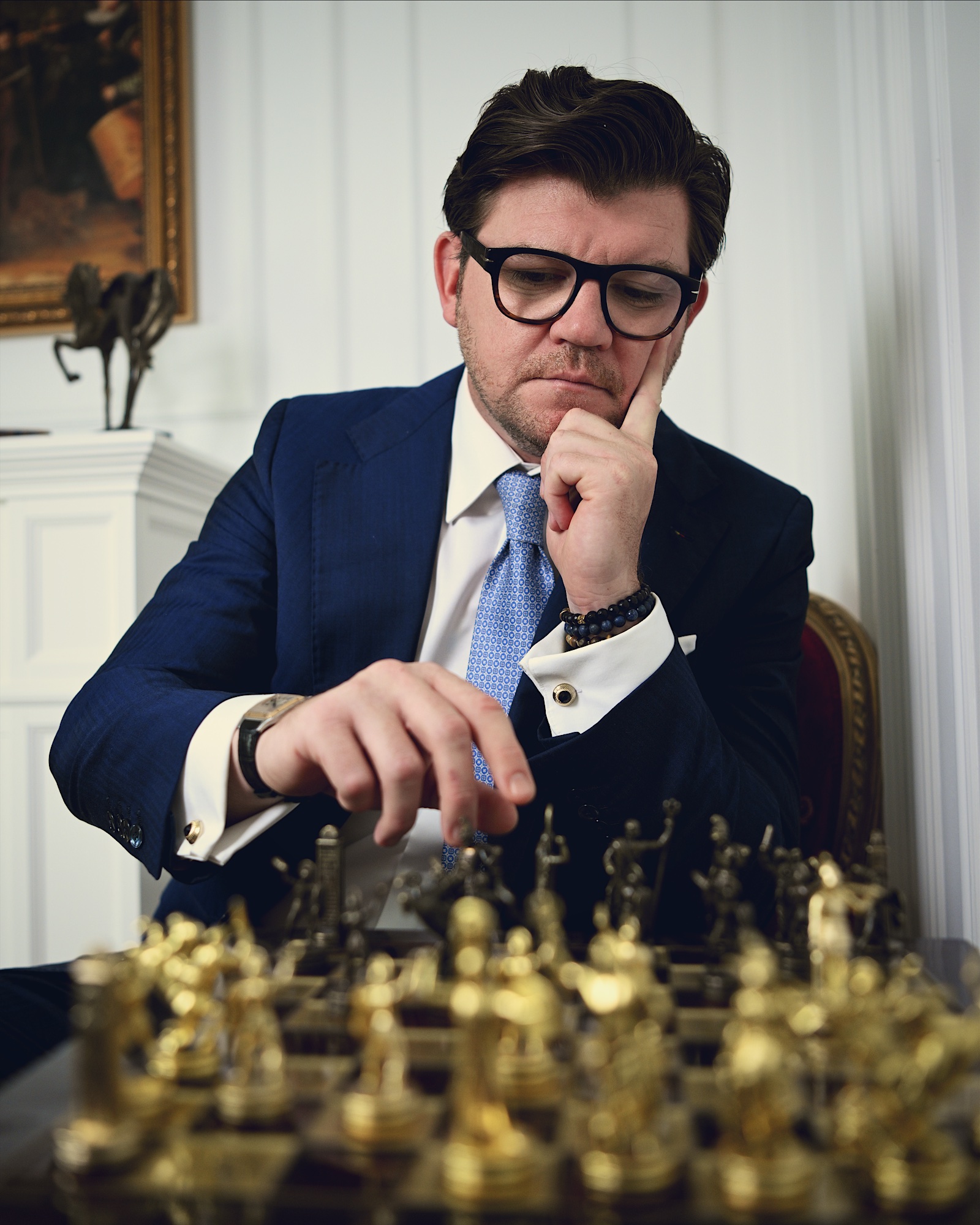 Anton Pisaroglu seated at a chessboard, considering the pieces.